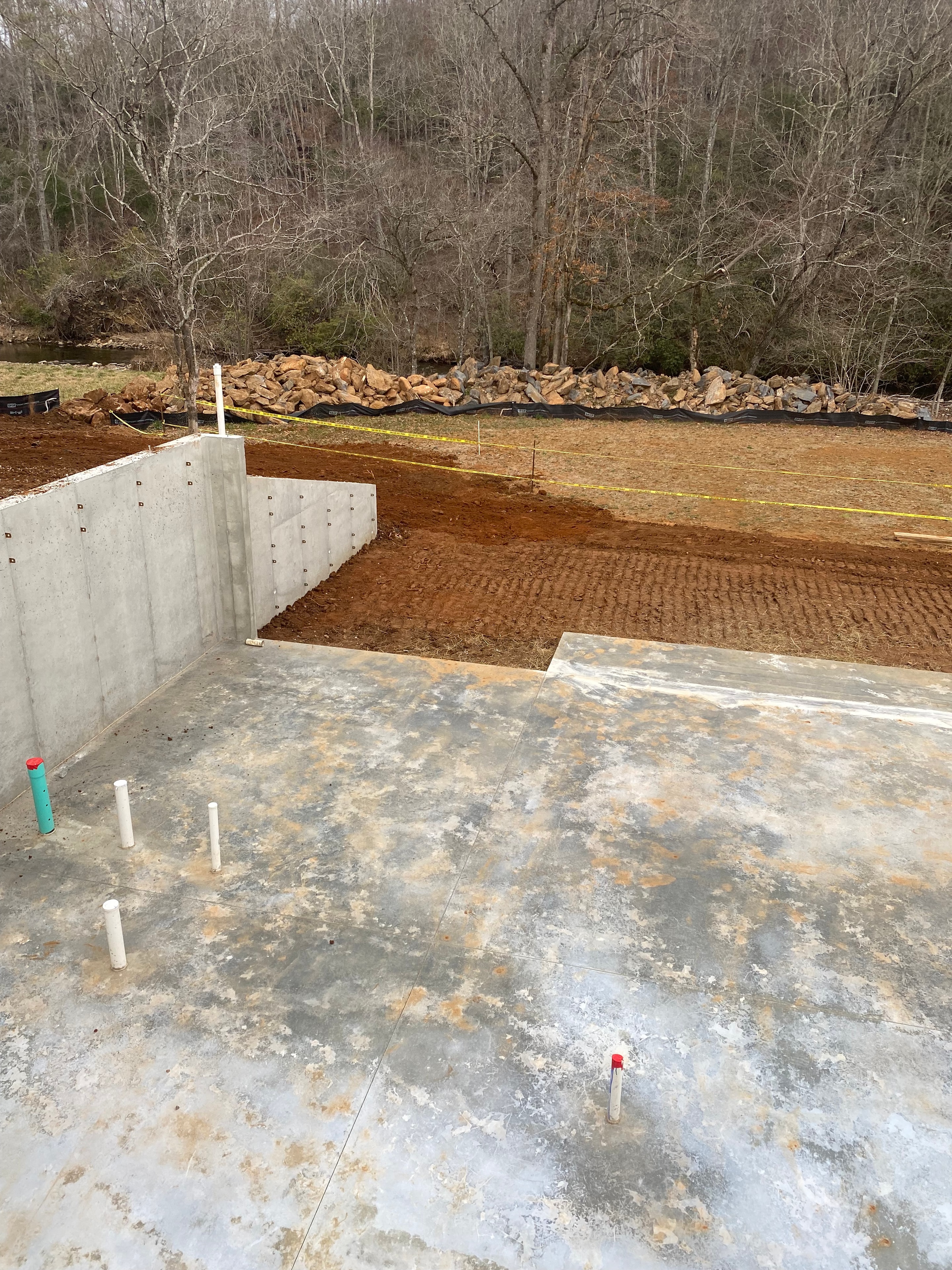 Concrete foundation construction site with bare trees