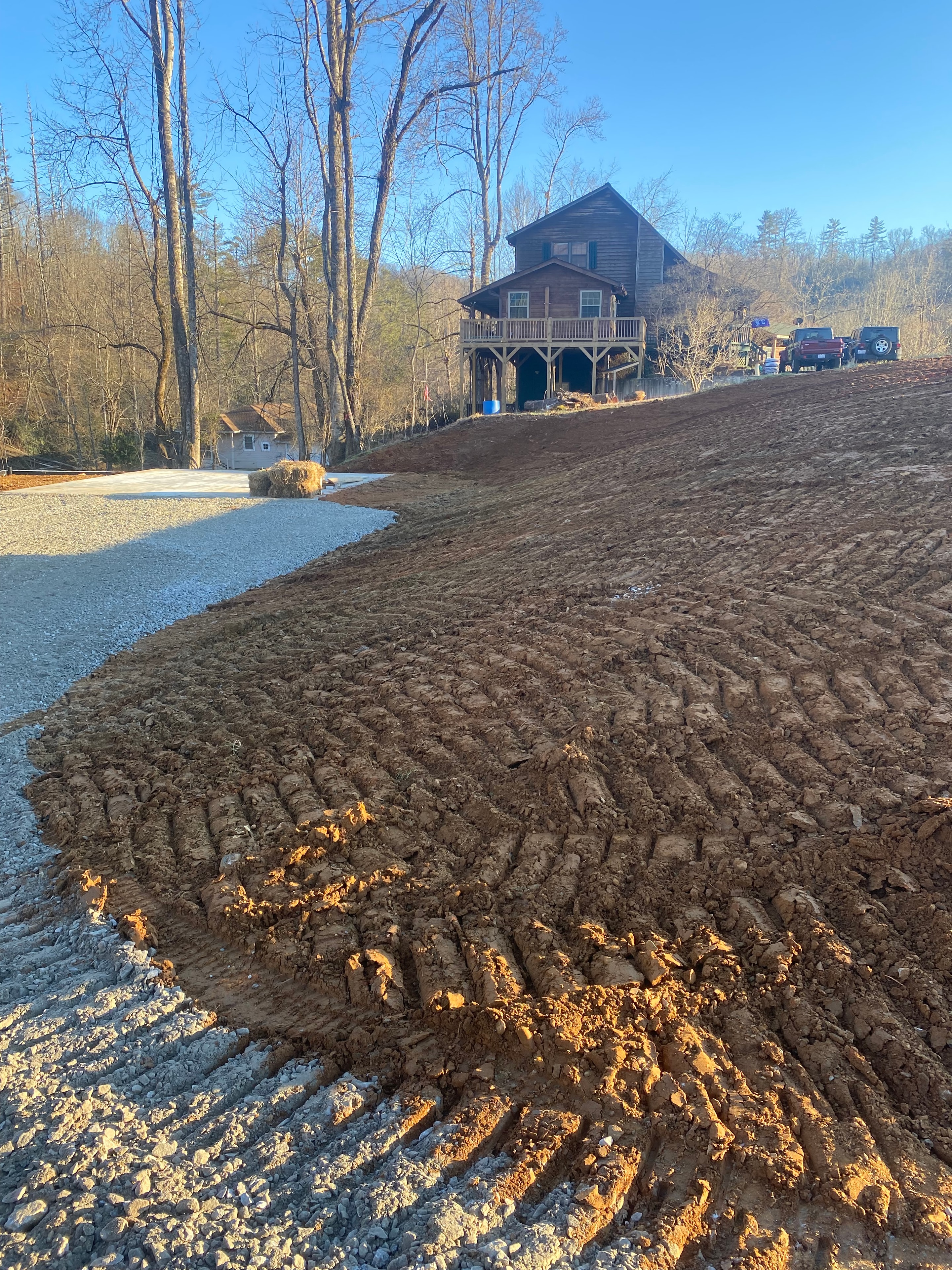Rural farmhouse with plowed field
