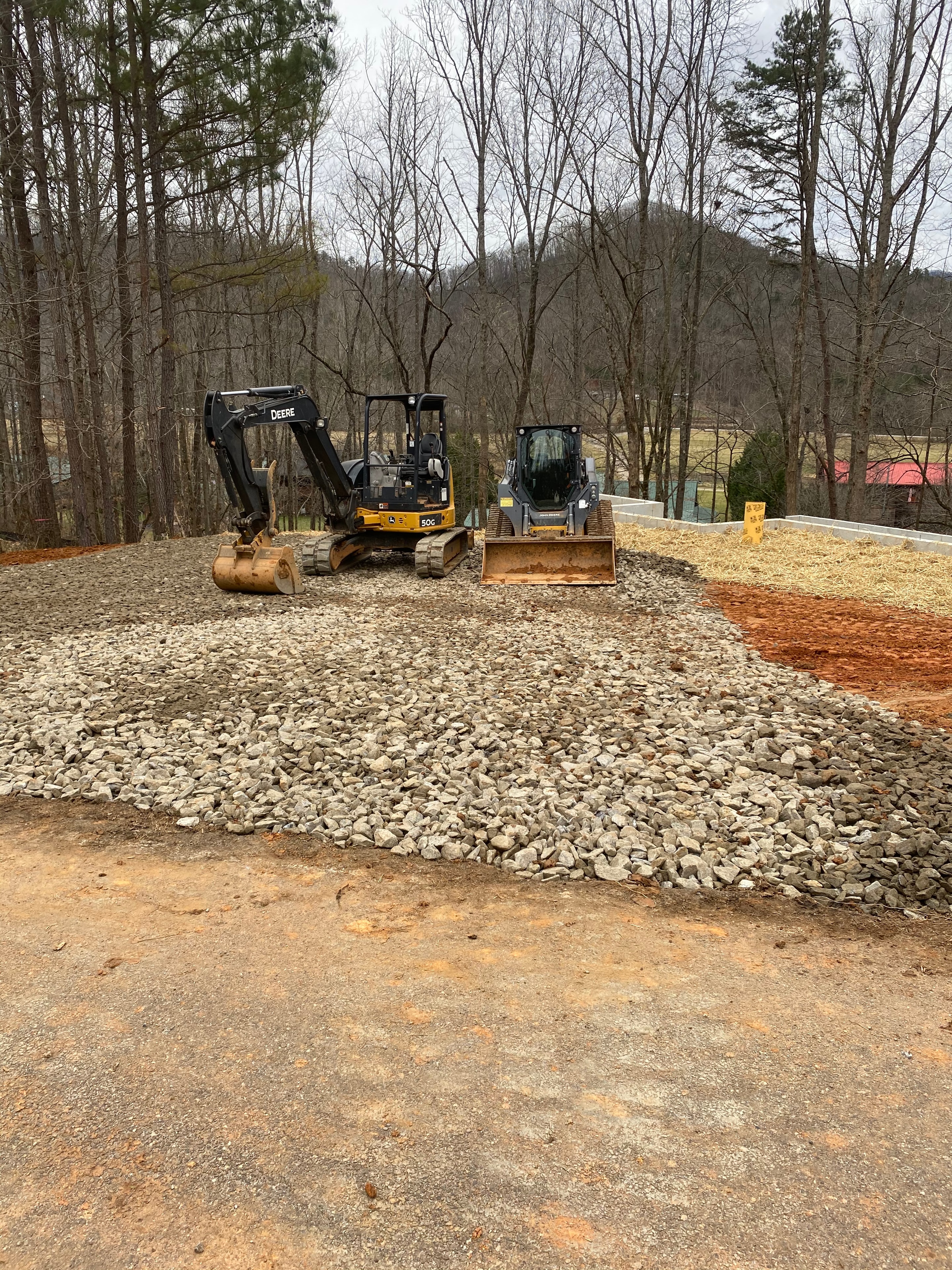 Construction equipment grading a driveway site